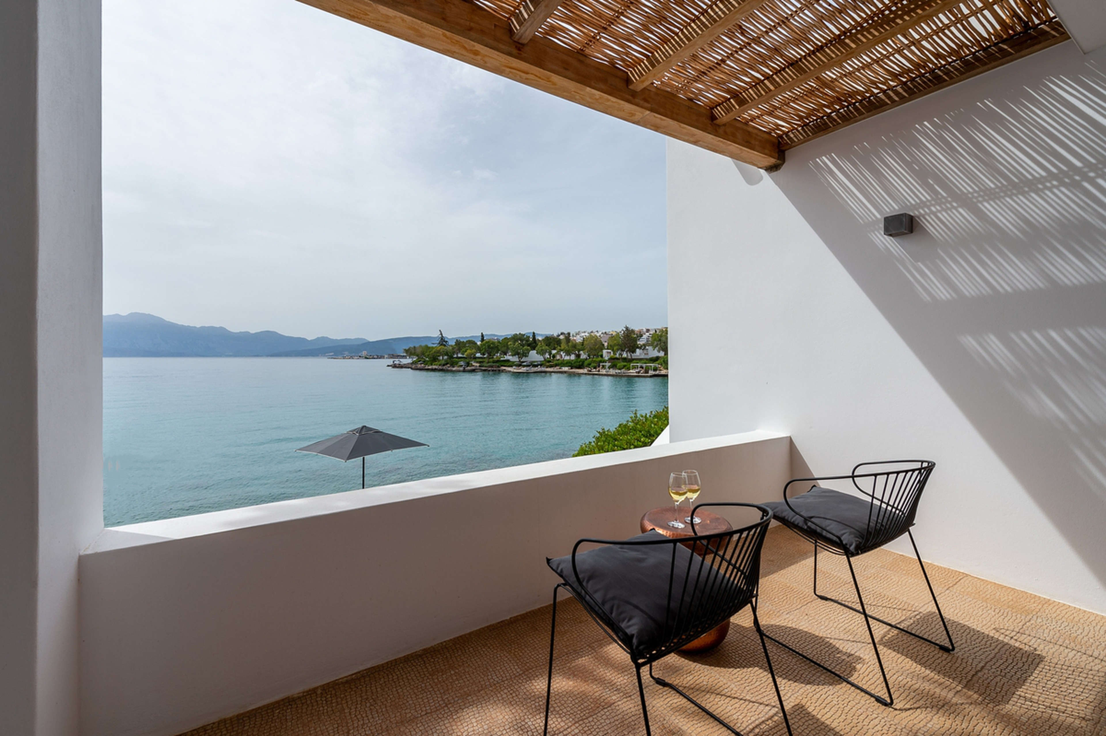 A beachfront hotel balcony at Minos Beach Art Hotel, a Member of Design Hotels