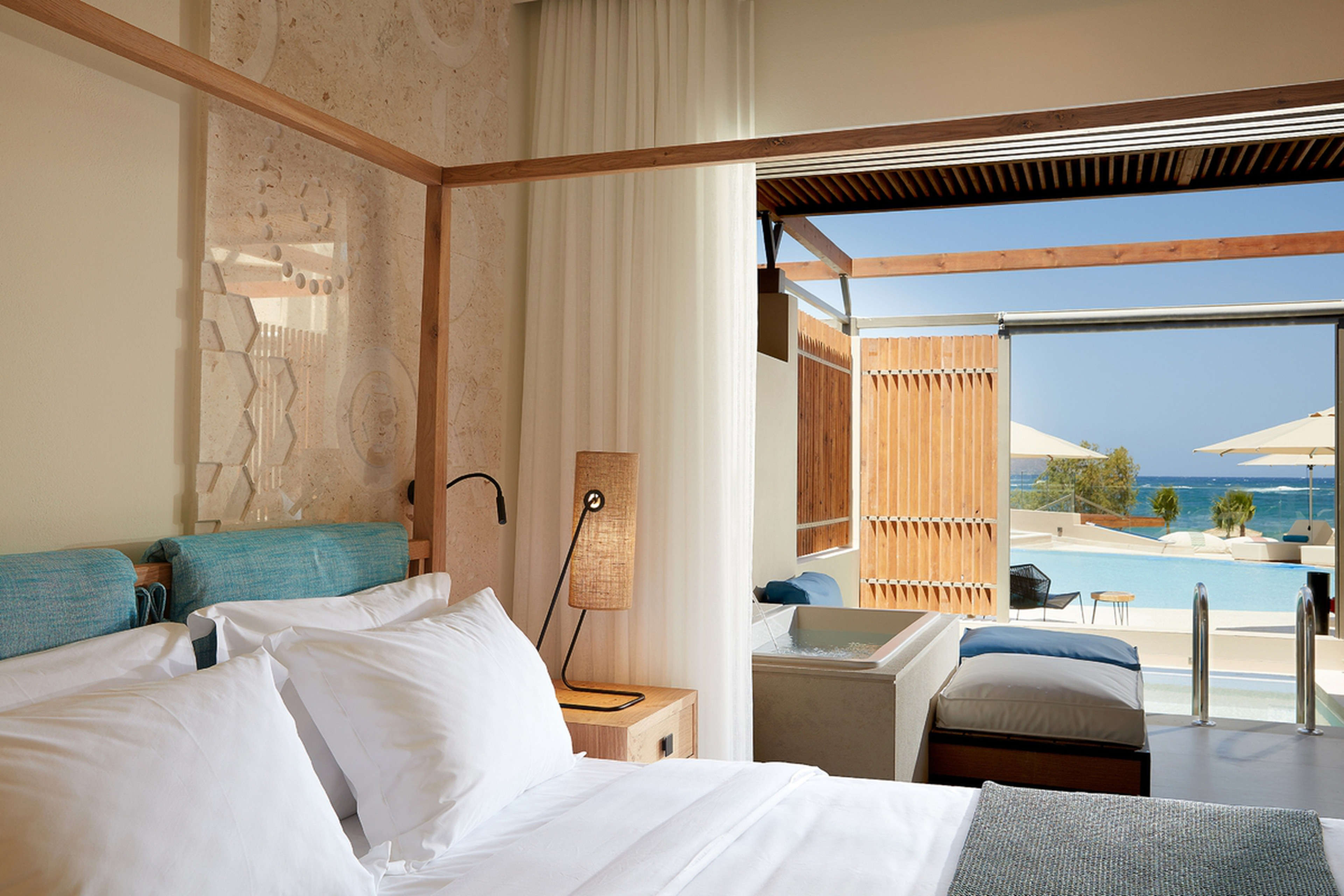 A hotel room with beach and pool view at Domes Noruz Chania, Autograph Collection