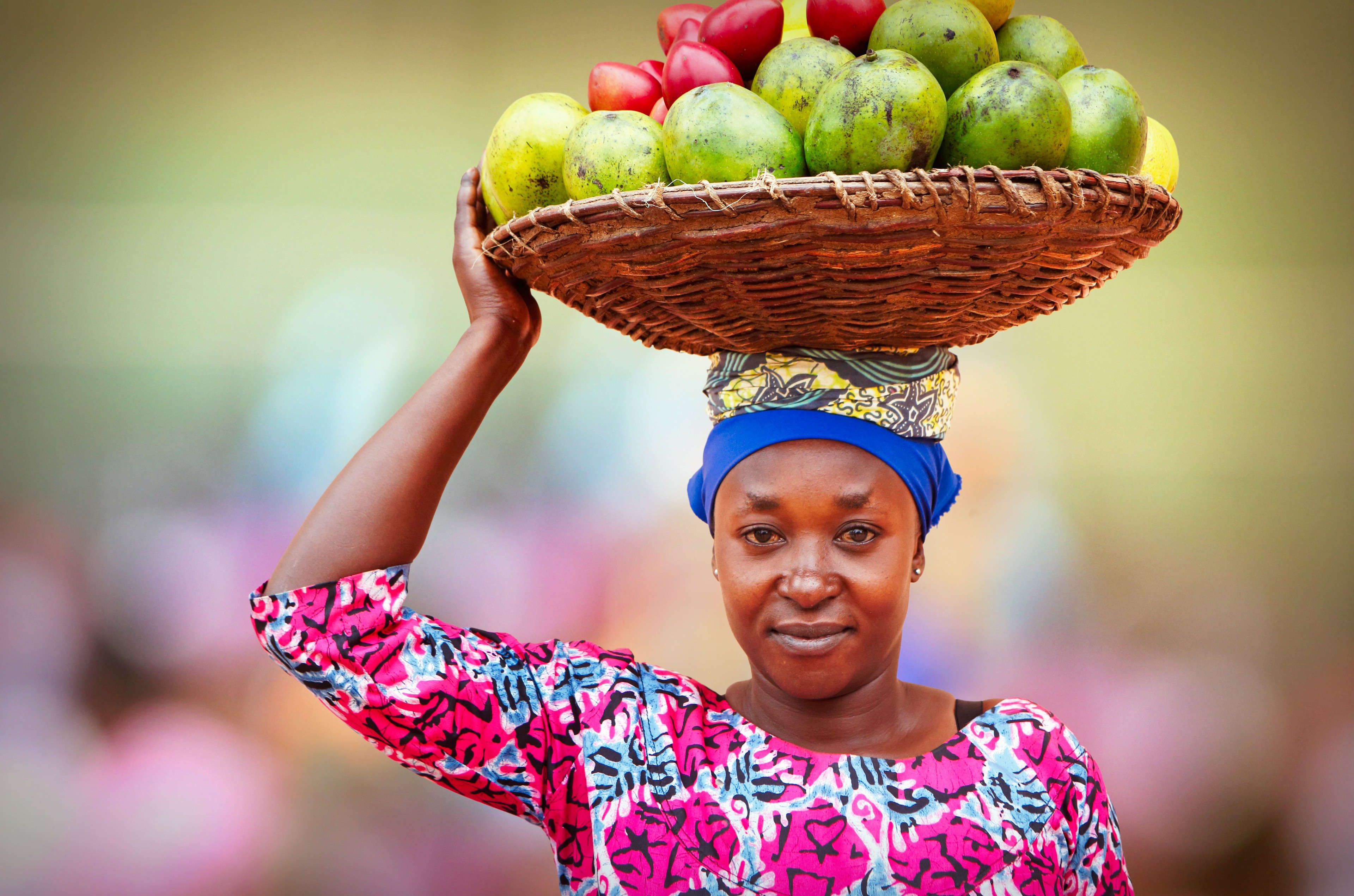 A woman carrying fruit, Kigali market