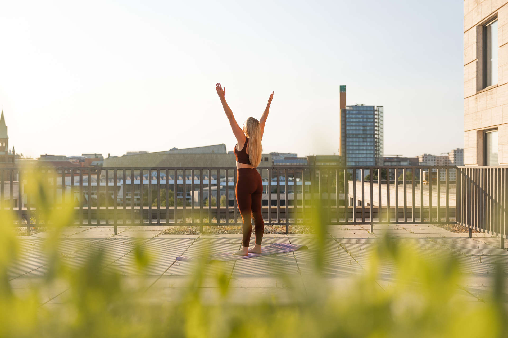 A woman does yoga on the rooftop at JW Marriott Berlin