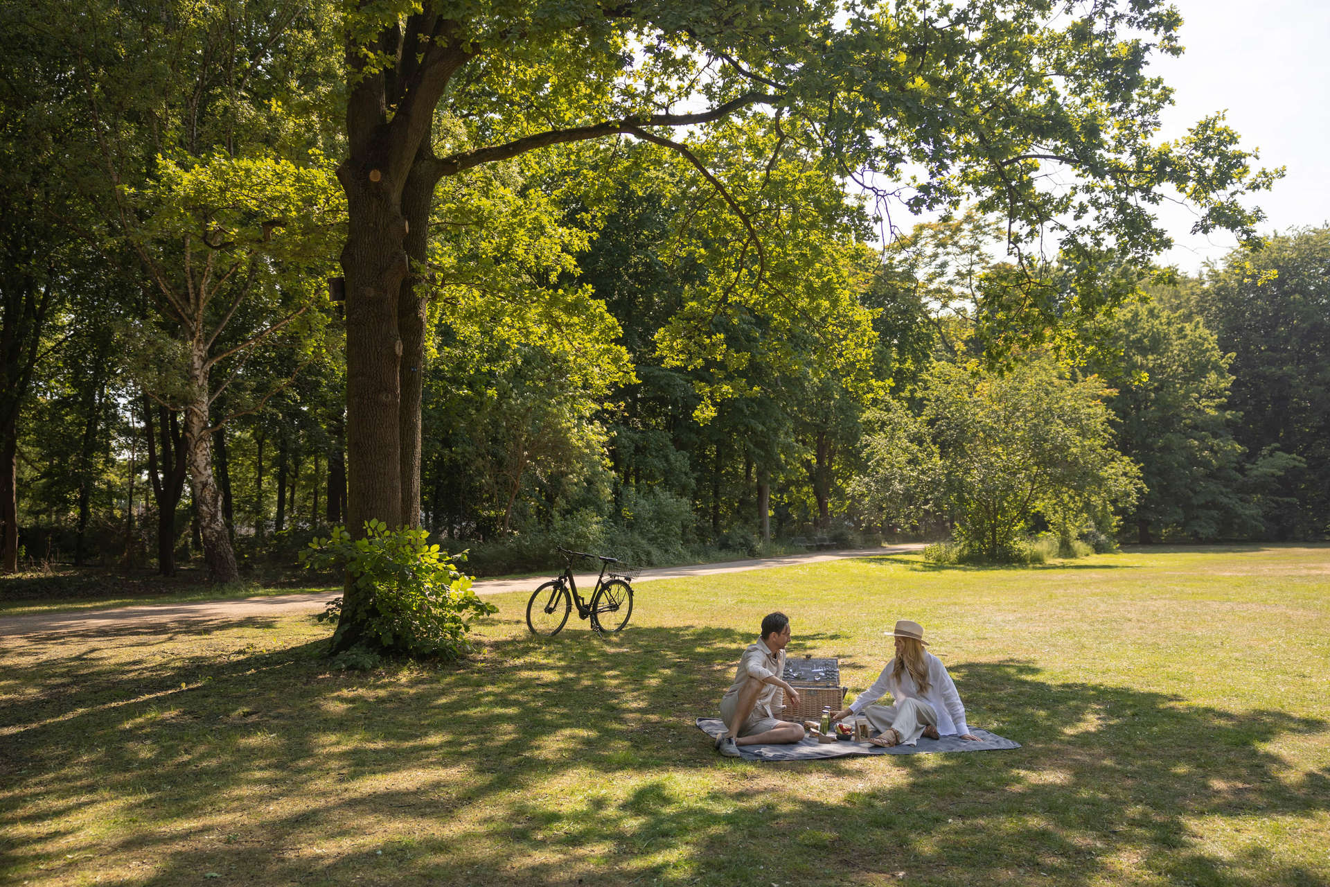 Couple enjoy picnic in Tiergarten Park.