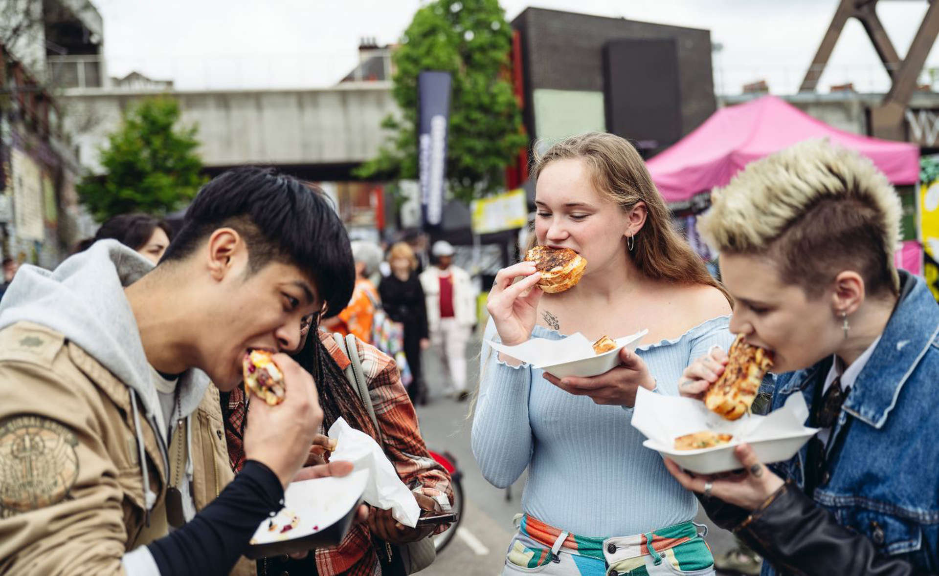 Friends enjoying street food at Borough Market, London