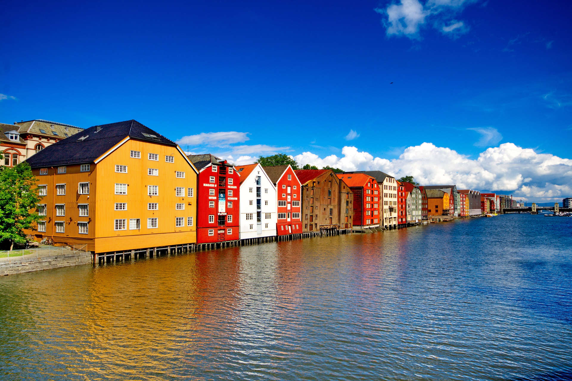Houses By Lake Against Blue Sky