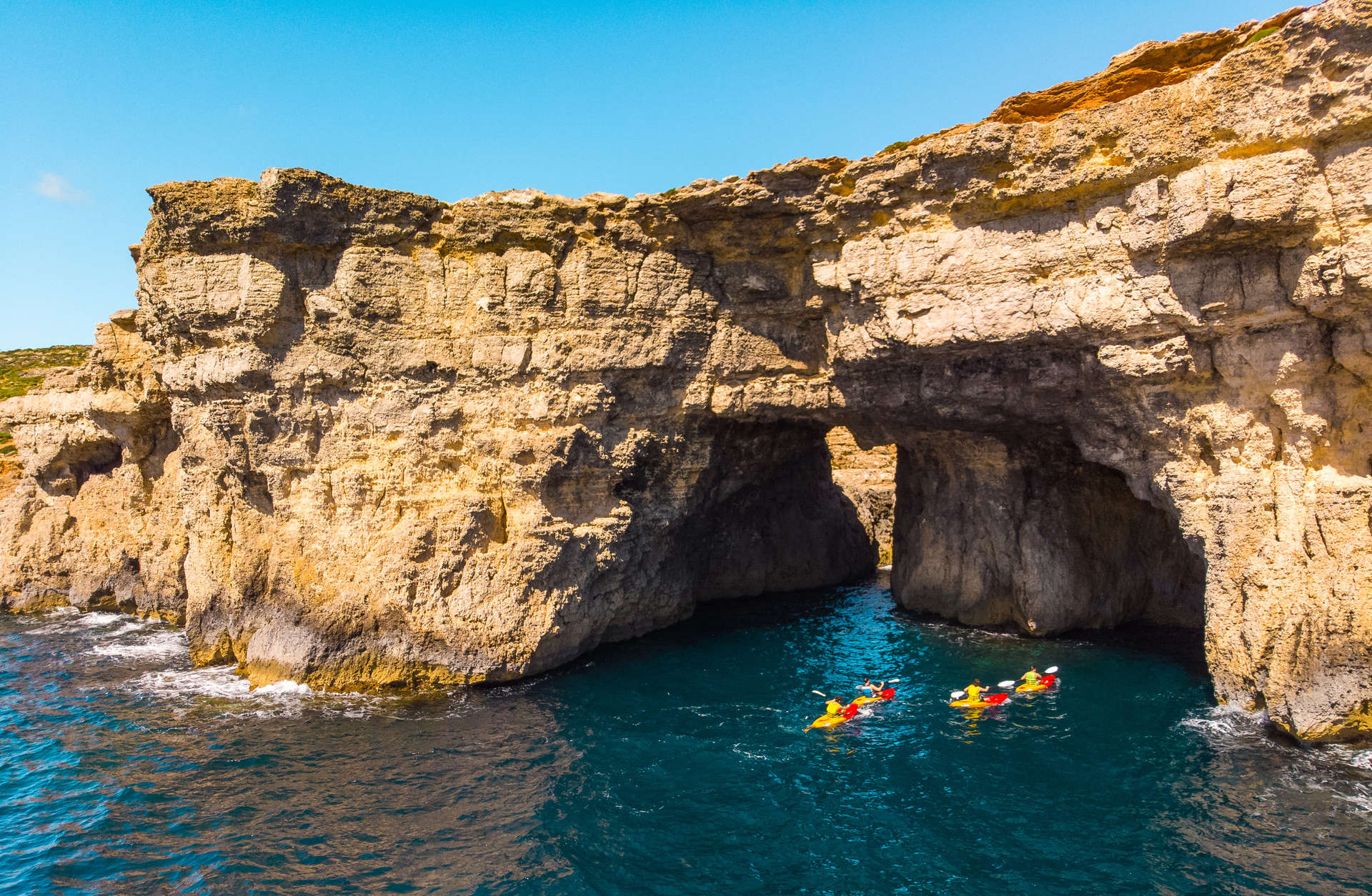 Kayaking shoreline clear blue sea water