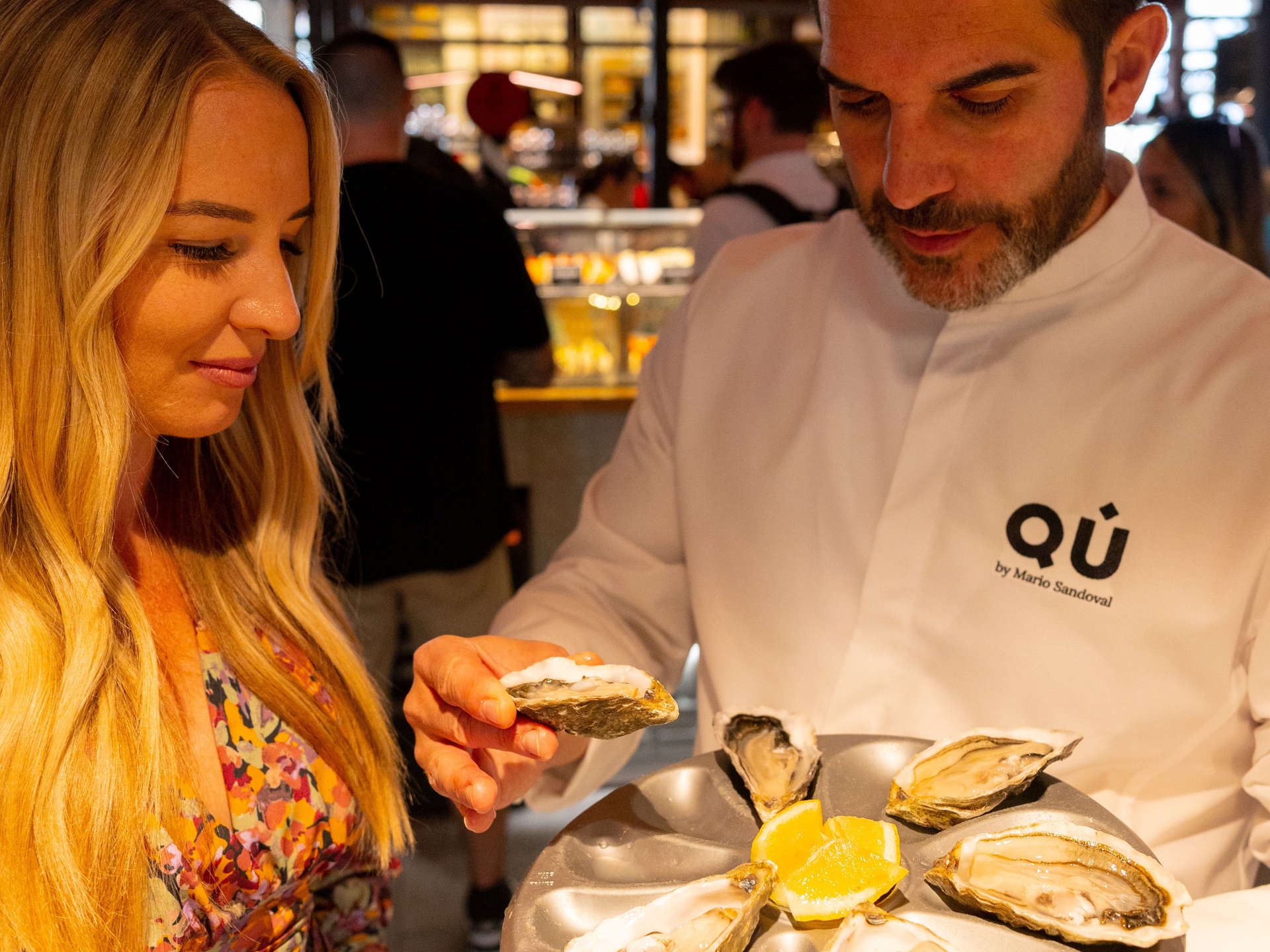 Man and woman taste local cuisine at a Madrid market