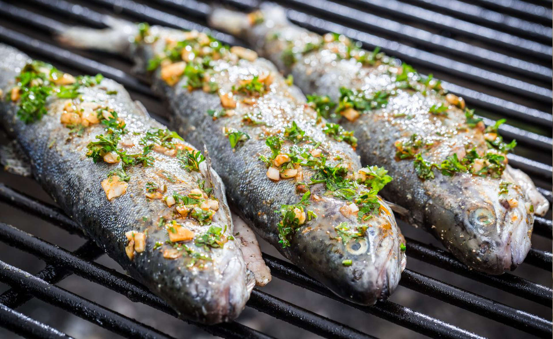 Middle Eastern cooked fish topped with herbs and garlic