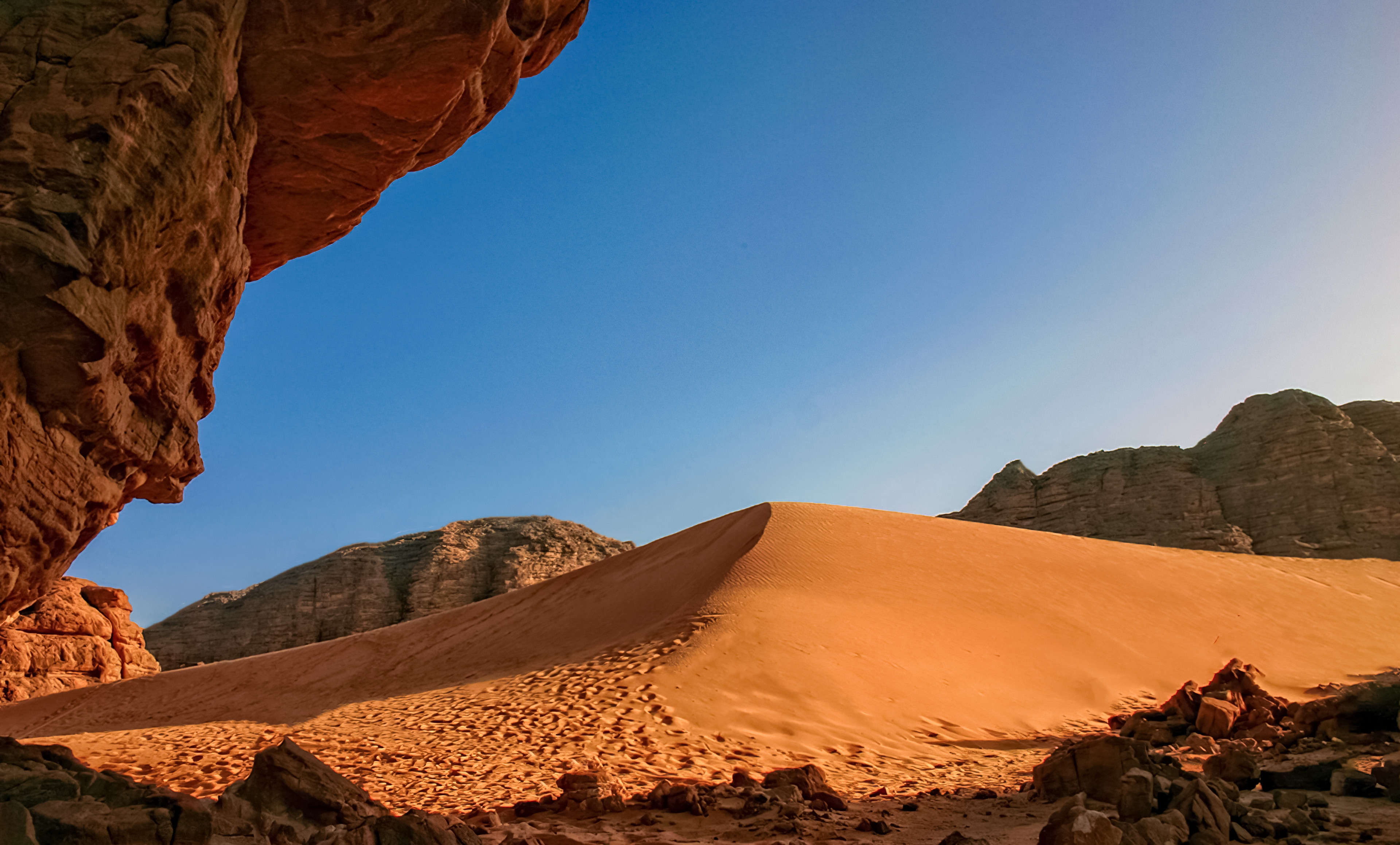 Sand dunes and rock formation in the Sahara desert