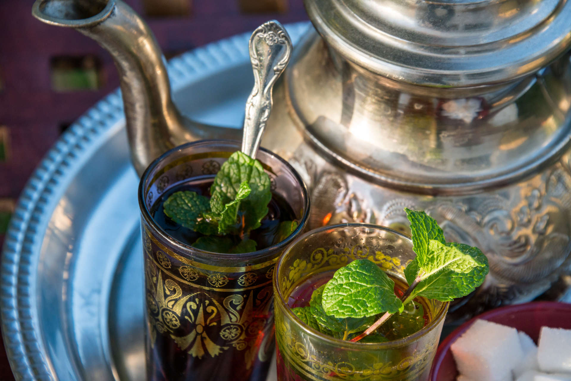 Traditional Moroccan mint tea in a traditional cup with mint leaves
