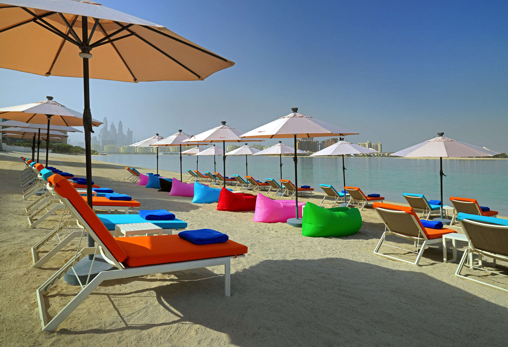 Sink into your sun lounger on Aloft Palm Jumeirah's private beach
