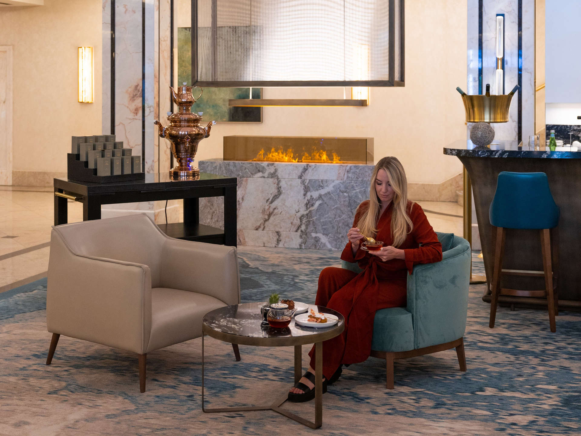 Woman enjoys tea and cake in the JW Marriott Berlin Lobby Lounge