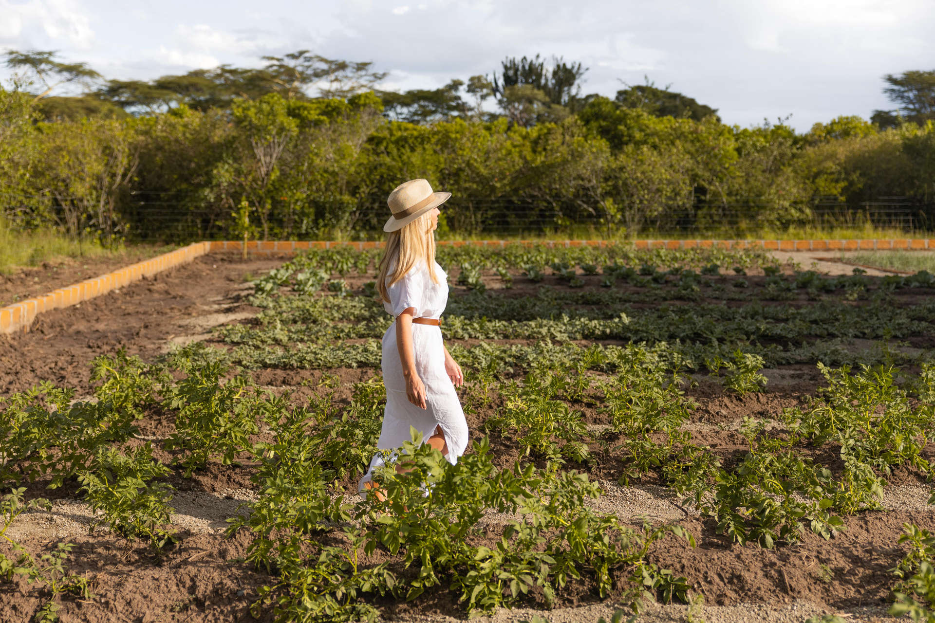 Woman explores herb and veggie garden at JW Marriott Masai Mara Lodge