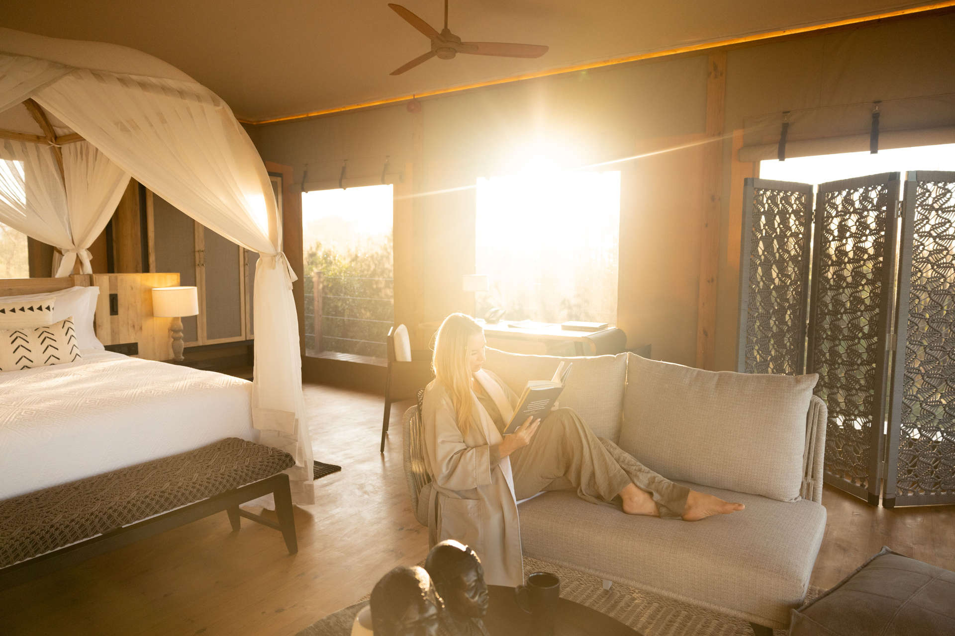 Woman relaxing in her room at JW Marriott Masai Mara Lodge